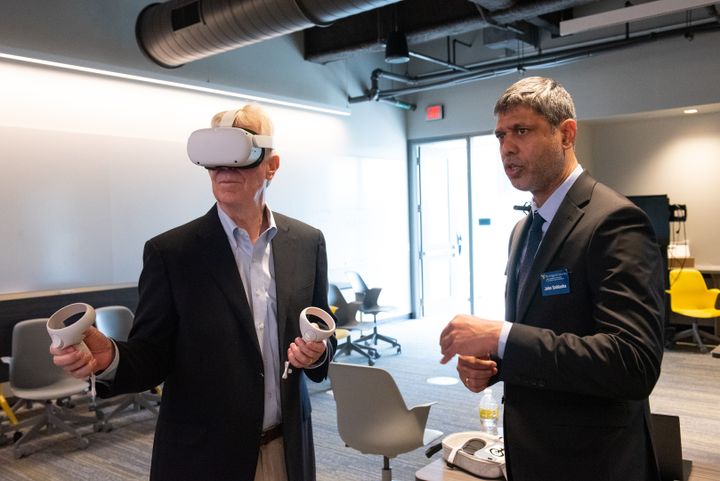 Bernie Wehrle trying out VR goggles with John Saldanha