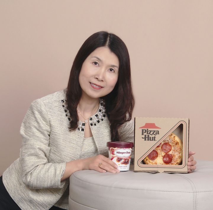 Photo of Annie Cui holding pizza and ice cream