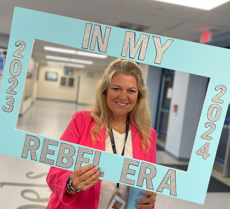 Photo of Kristin Morvik holding big picture frame with text "In My Rebel Era"