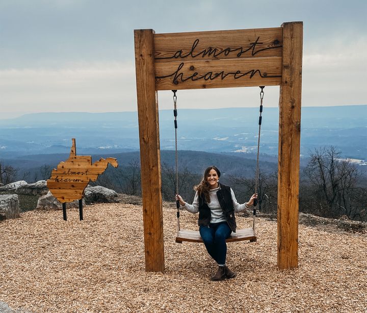 Photo of Carrie Digman sitting on a swing at Cacapon State Park
