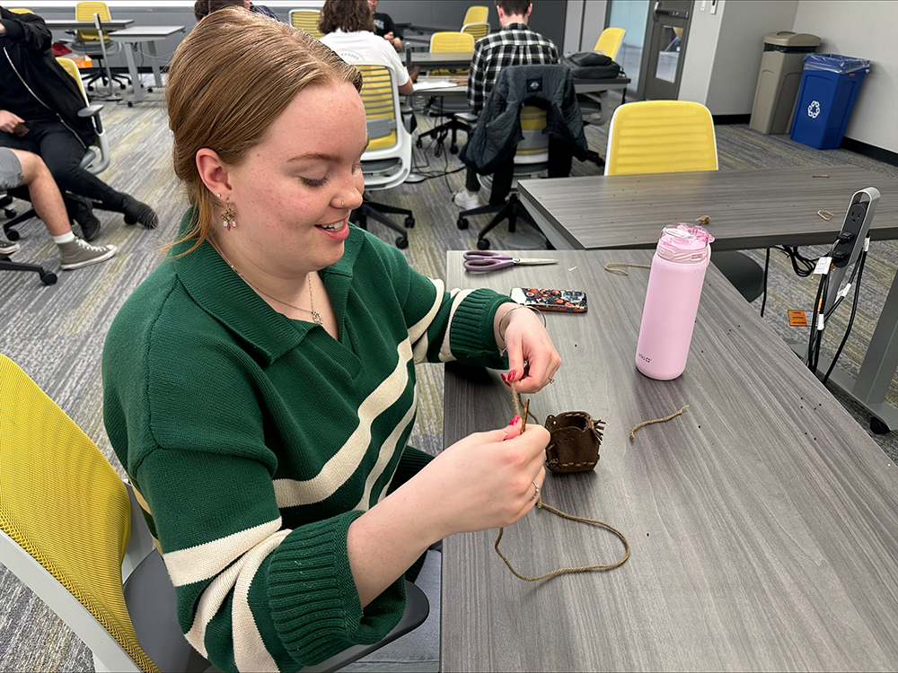 Photo of student knitting Mountaineer booties