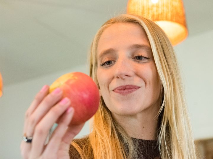 Photo of Mal Moholt inspecting an apple